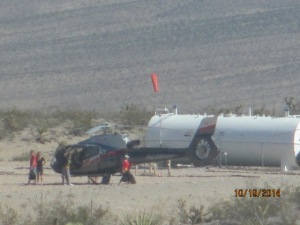 Close up of chopper with passengers getting out to stretch their legs.